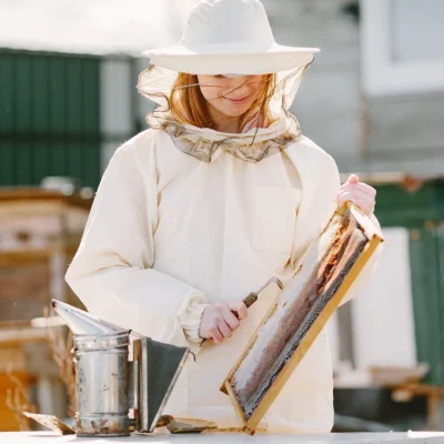 woman-beekeeper-looks-after-bees-wearing-coverall-woman-work-apiary